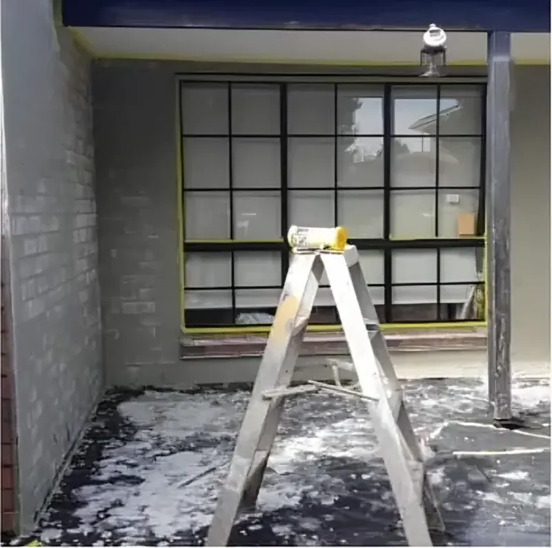 During: render going on over the brick porch