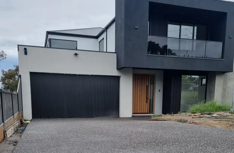 Two-storey home with smooth render beside cladding
